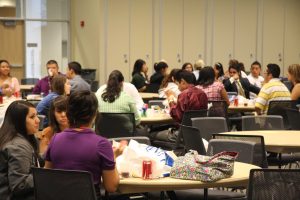 Latino students mingle with professionals while having lunch
