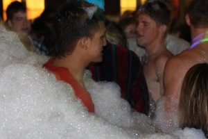 Students wading in the deep flow of foam