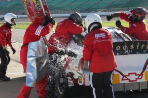 An ARCA car spews gas in a pit stop