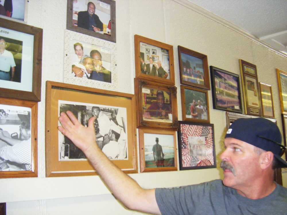 Visitor from Colorado Springs admiring the wall of photos. Many celebrities have come to experience the tasty barbeque.