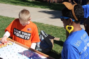 Bianca James engages with a young participant in the Kidney Walk. 