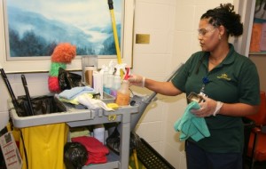 A Campus Facilities employee using the eco-friendly cleaning products.