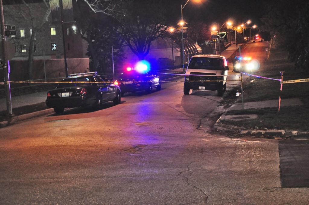 Police interceptors and yellow tape blocked off a section of East 51st Street as officers removed a body from the grounds at Linda Hall Library.
                                                                                   Photo by Nathan Zoschke	