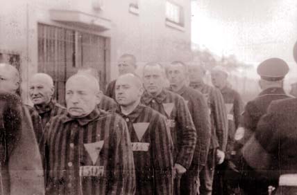The upside down pink triangle was used to distinguish homosexuals in concentration camps, as seen on their shirts CREDIT // National Archives