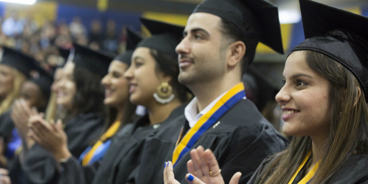 Students standing at a commencement when in-person commencement was possible