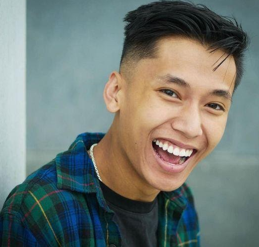 UMKC theatre student Hieu Bui smiling and laughing