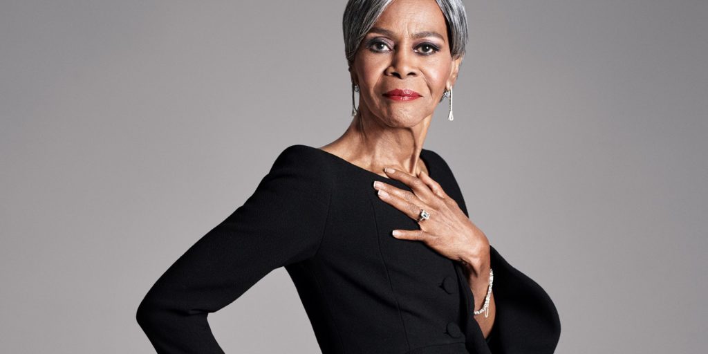Late-actress, Cicely Tyson, posing in her later years in a black fitted dress.
