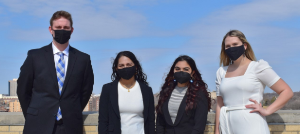 Four UMKC students standing from left to right, Kyle Potts, Malavika Rajaram, Mahreen Ansari, Abigail Weiler.