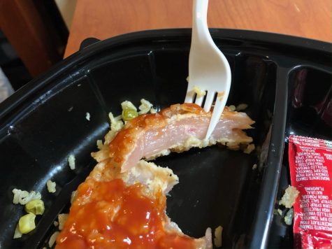 A student notices that their meat is undercooked after cutting it open