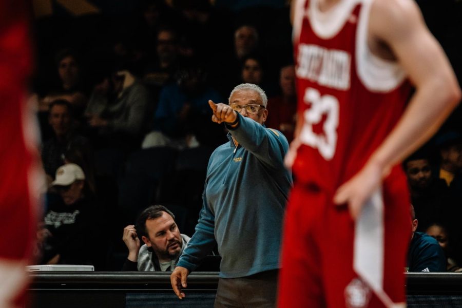 Coach Marvin Menzies on the sidelines leading the team.