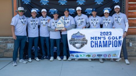 The Kansas City Roos mens golf team posing with the Summit League trophy.