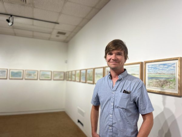 Snell stands in front of his work in the UMKC Gallery of Art.