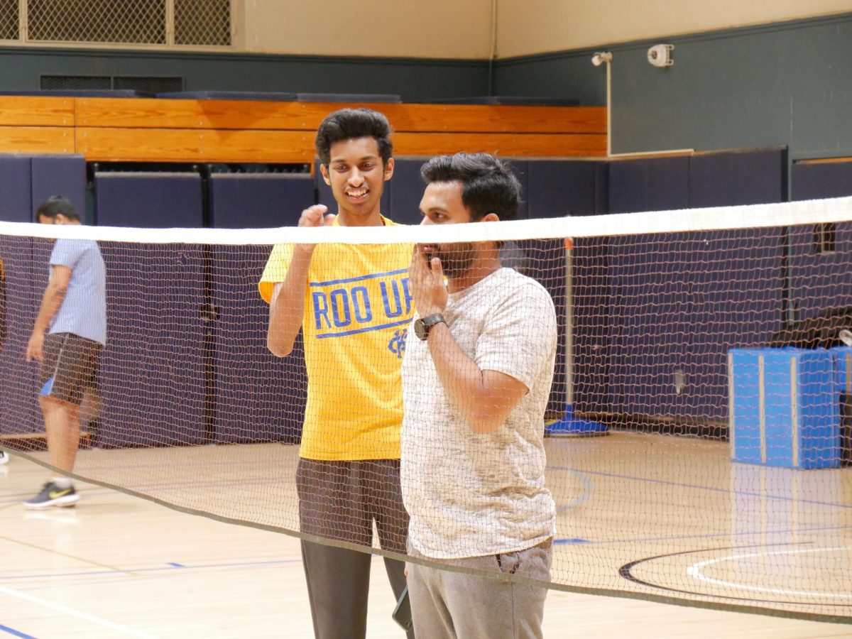 Vice President of Badminton Club, Jayanth Kumar (left) and President Rahul Reddy (right) check the net height.