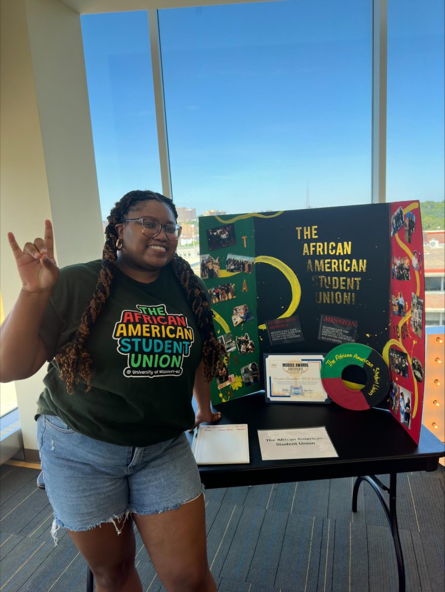 President Khyra Curtain highlights her organization at a tabling event. 