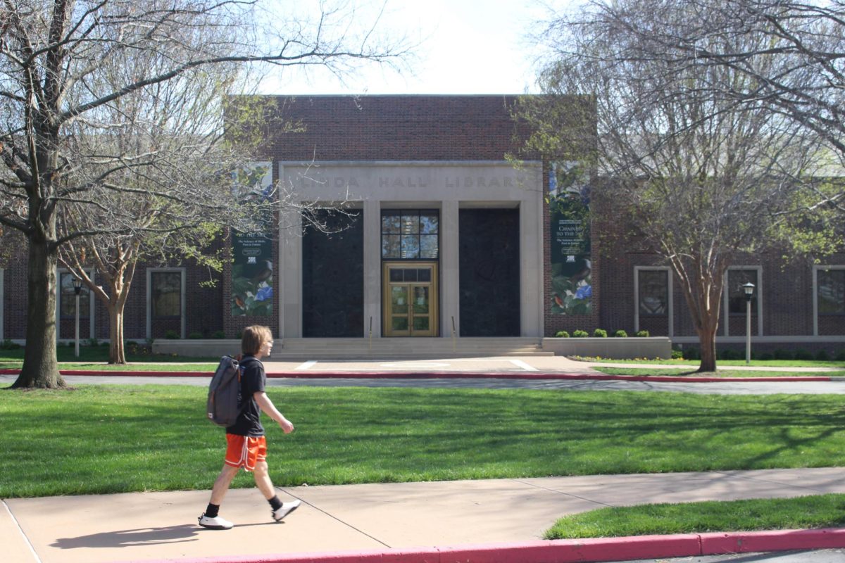 Student walking in front of Linda Hall Library. 