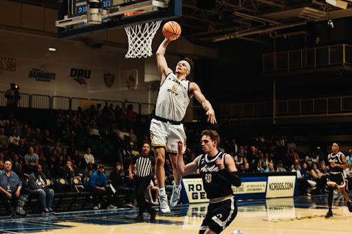 Jamar Brown dunks the ball against the Avila Eagles on Nov. 6, 2023.