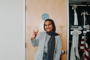 Yasmen Hassen standing in front of the SGA office. 