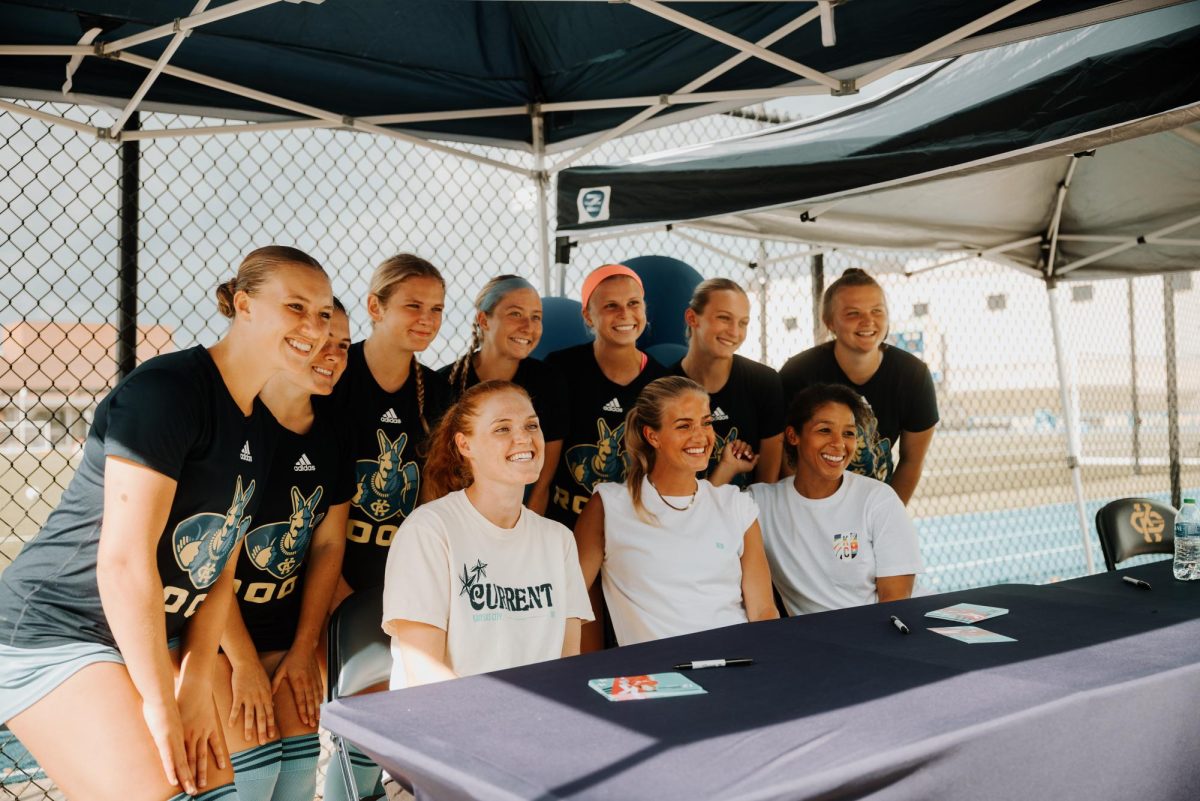 KC Current players take a picture with the Roos women's soccer team. 