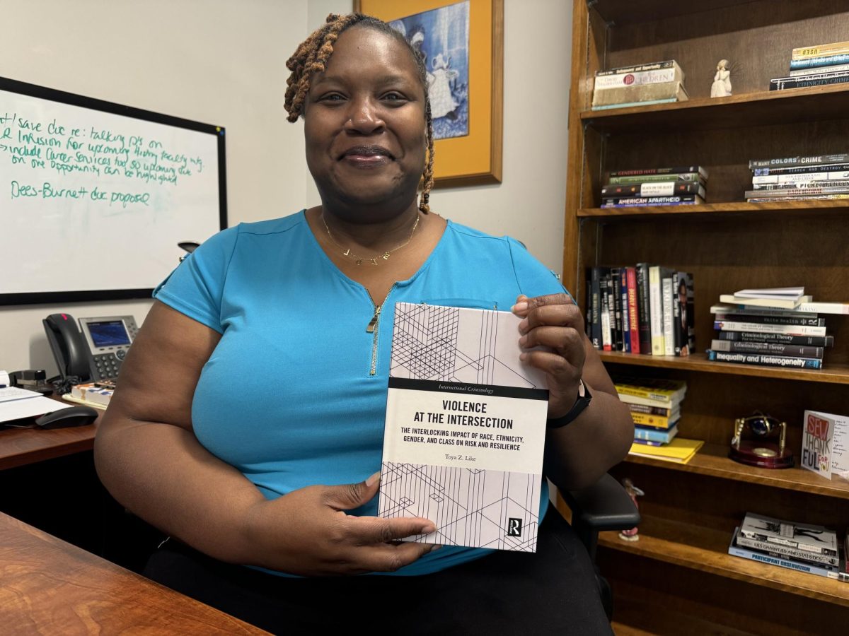 Dr. Like with her new book in her office. 