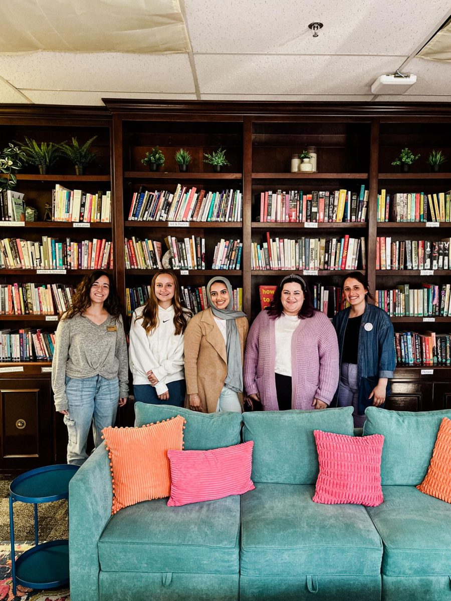 The Women's Center staff in front of their library. 