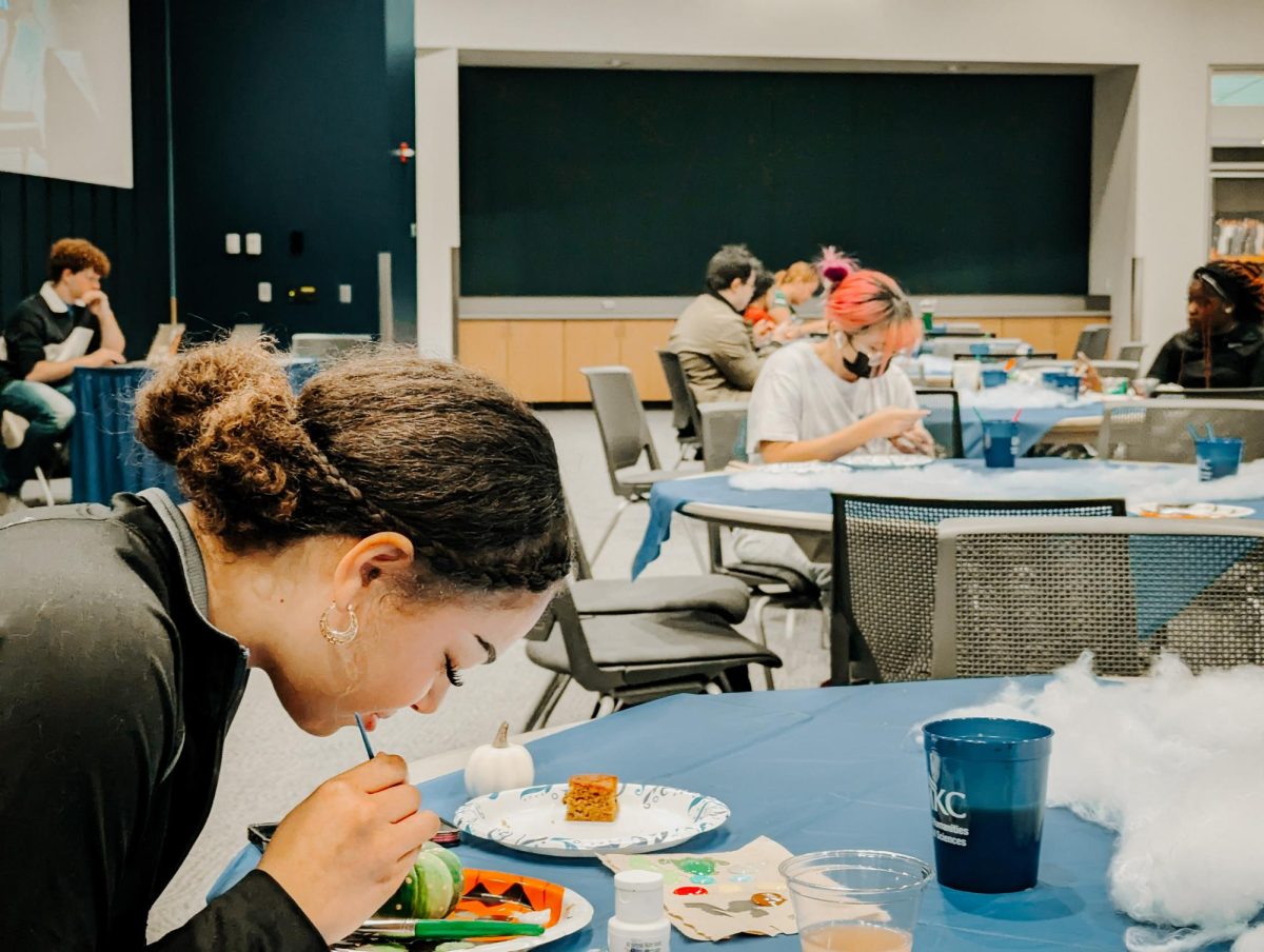 The finishing touches are added to one UMKC student’s painted pumpkin.