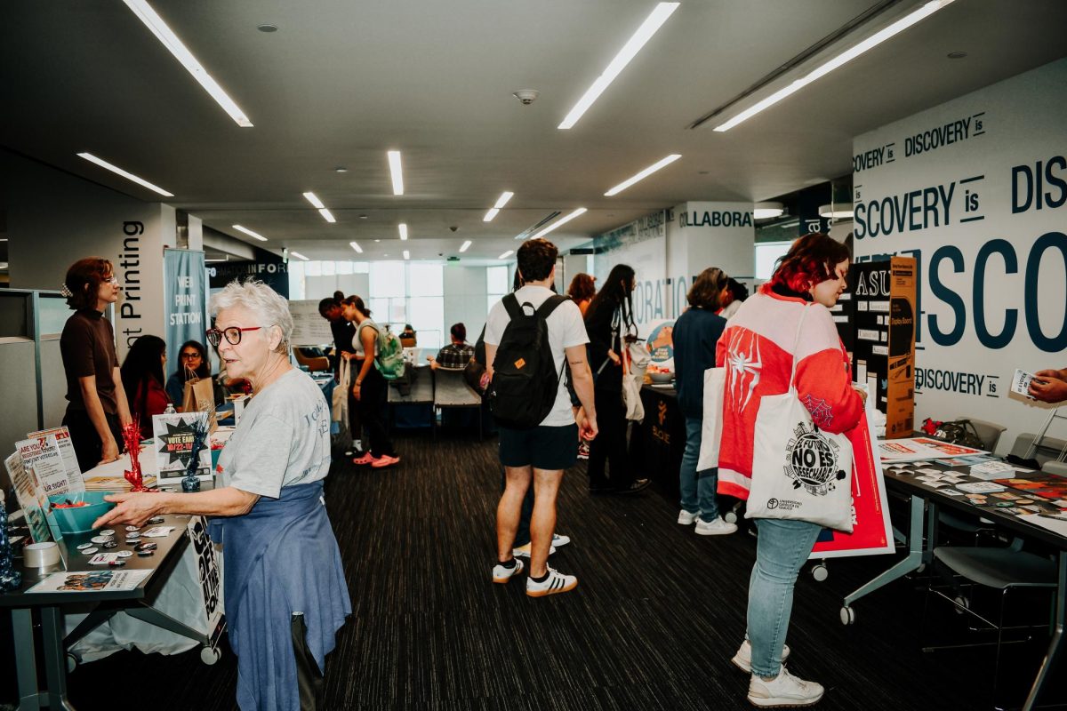 Students walk around voter resource fair.