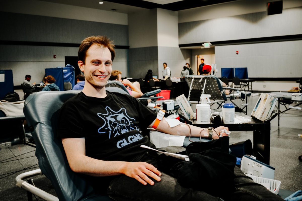 Library employee Harry Brewster donating blood for the first time.