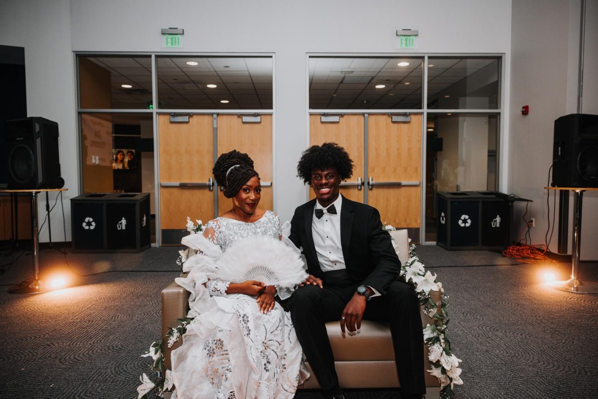 The groom and bride post together during their wedding. 