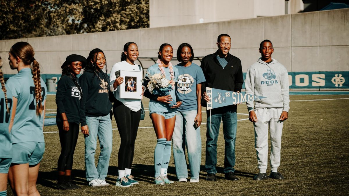 Senior Gabrielle Simms posing with family. 