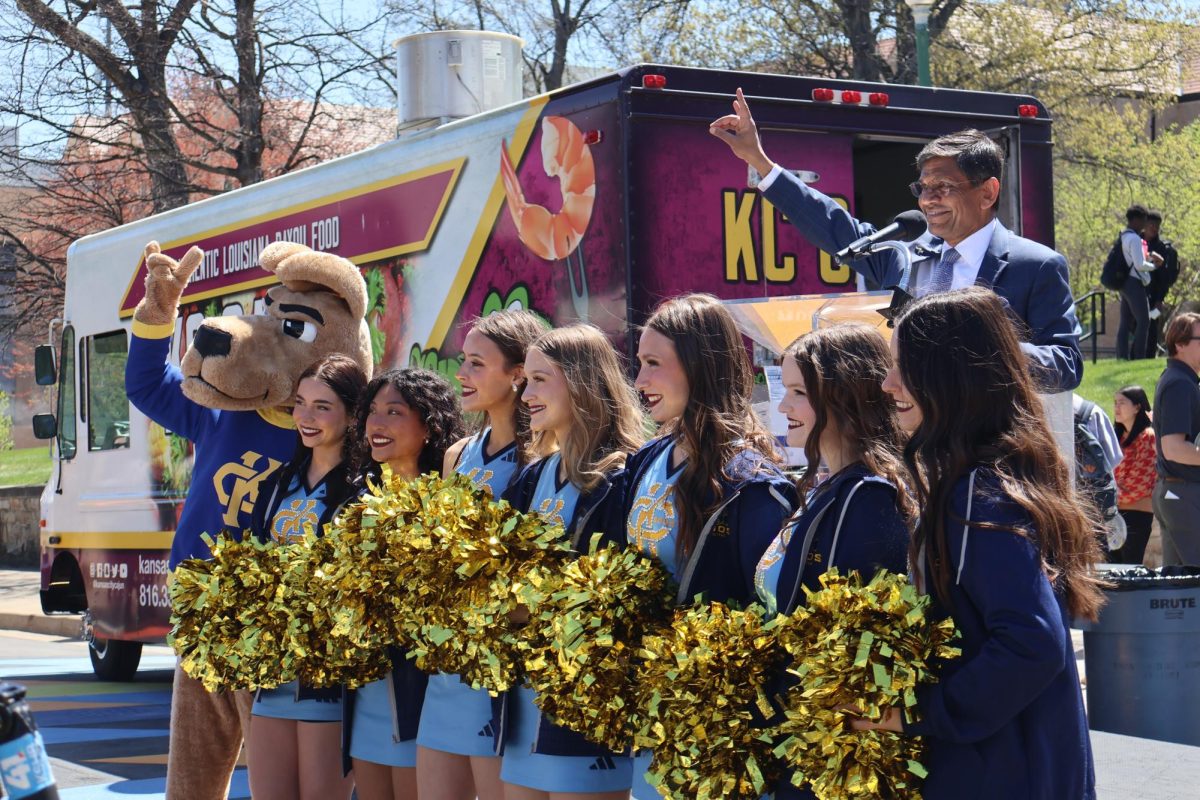 Chancellor Mauli Agrawal poses with Kasey the Kangaroo and UMKC cheerleaders. 