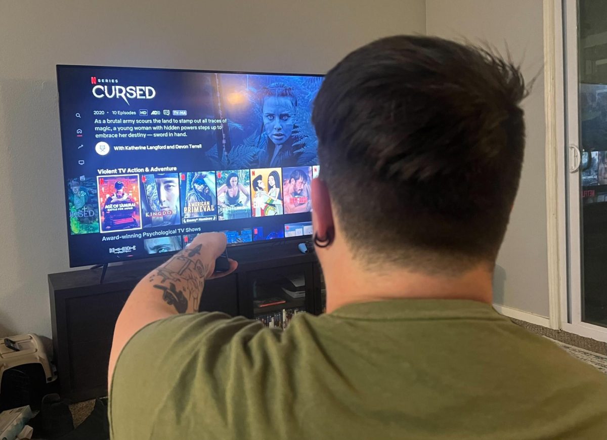 UMKC Grad Student Zach Hill scrolling on Netflix. 