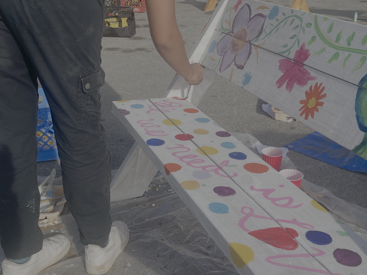 An attendee paints one of the nearly 30 benches built on Nov. 15.