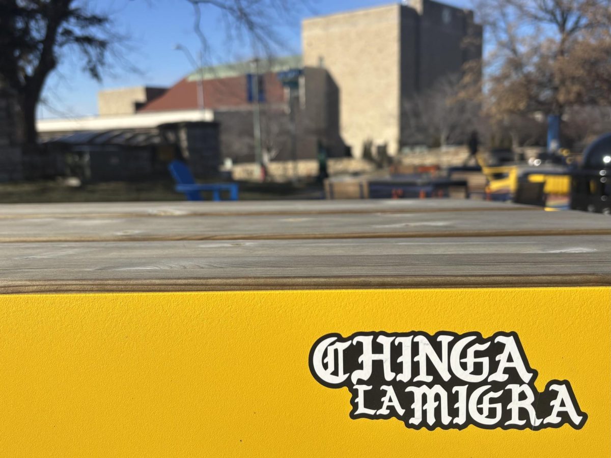 A sticker placed on a bench in Roo Plaza, reading “Chinga la Migra,”

which translates to “F-ck ICE.”