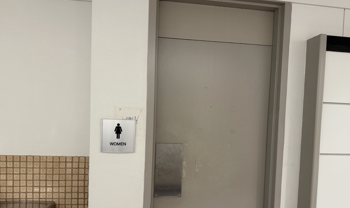Image of UMKC bathroom with changed signage