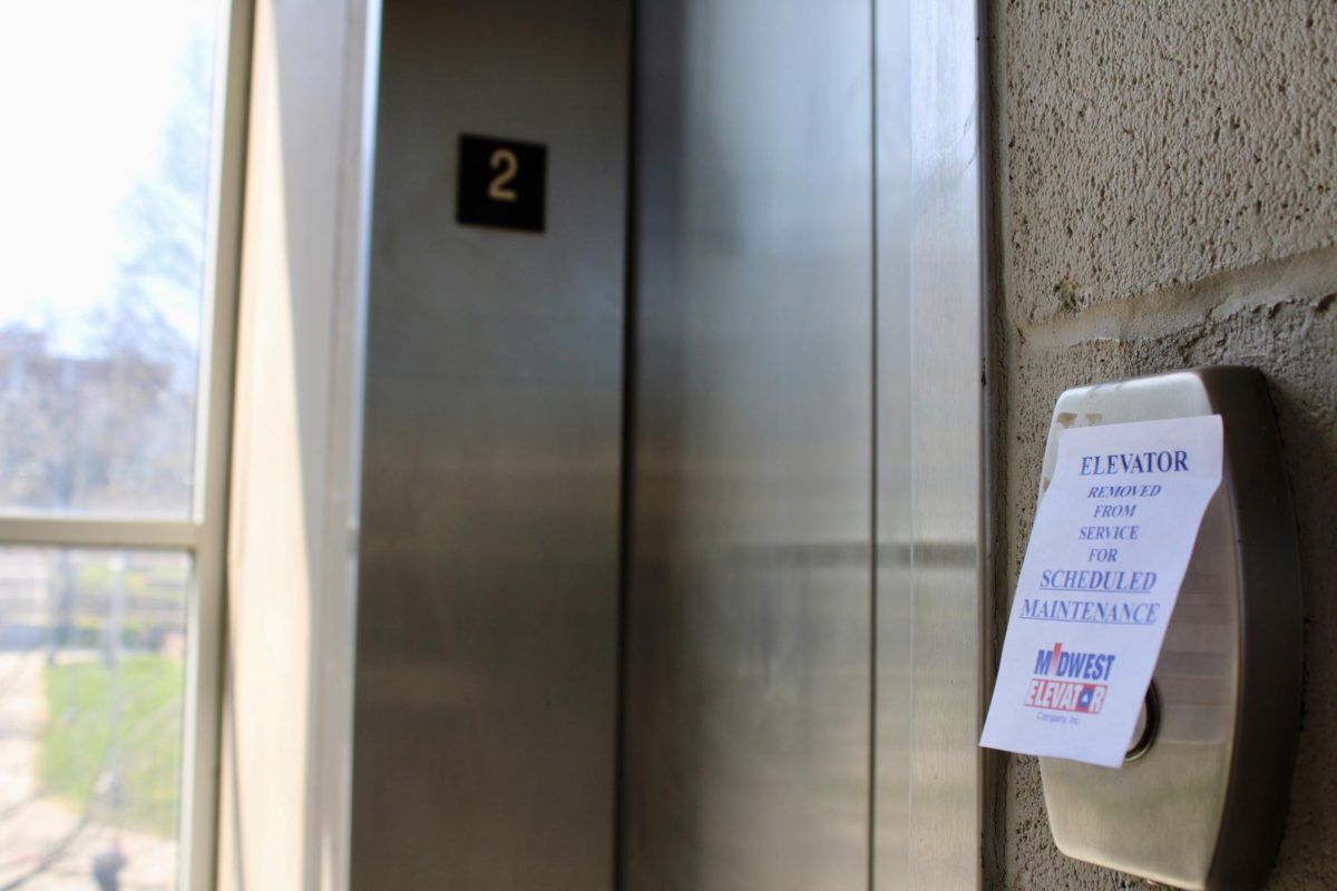 A post-it note letting students know the only parking garage elevator is out of service.