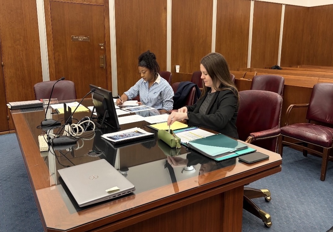 Karima Burns (left) and Bethany Holstead (right) looking over notes in preparation for a trial.