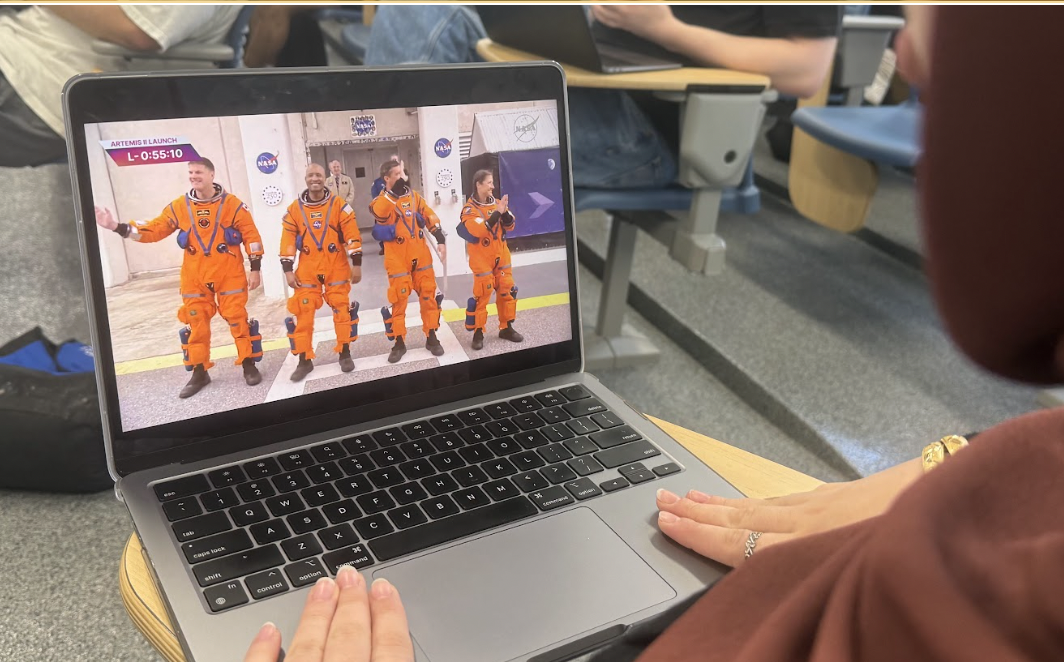 Student watching the Artemis II launch and the coverage shows the four astronauts prior to the mission (from left to right: Jeremy Hansen, Victor Glover, Reid Wiseman, Christina Koch).
